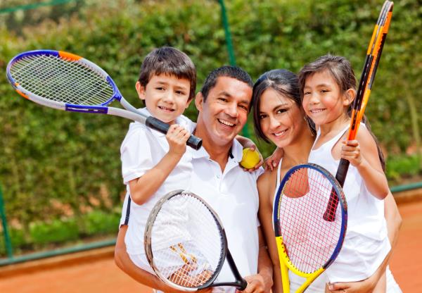 family playing tennis lesson